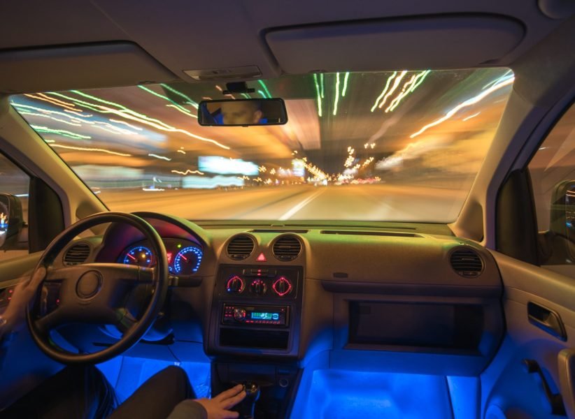 The man drive a car in the city with a lights. Evening night time